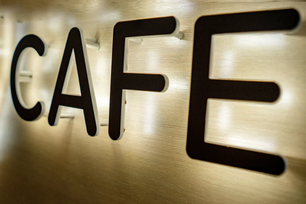 Different types of channel letters illuminated at night showing front-lit, halo-lit, and combination lighting effects on a storefront