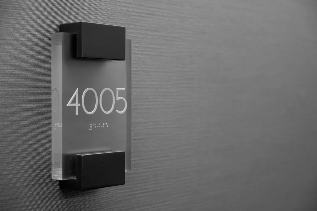 Braille Signs: Complete Guide to Accessible Tactile Signage, Types, Requirements & Design braille signs Braille sign with raised lettering and tactile Braille dots for accessible room identification.