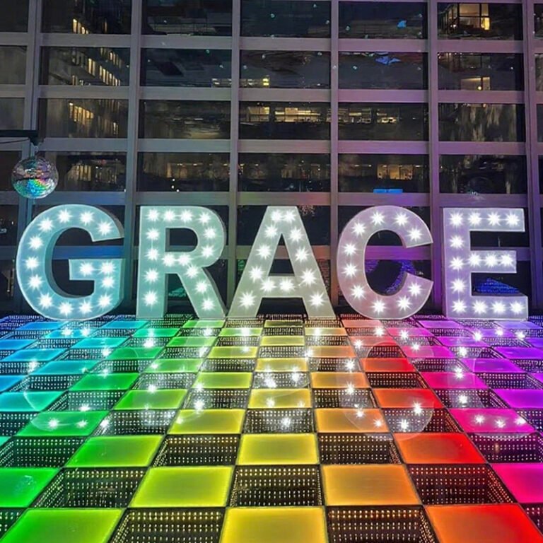 Vintage-style marquee letter lights spelling GRACE with visible illuminated bulbs